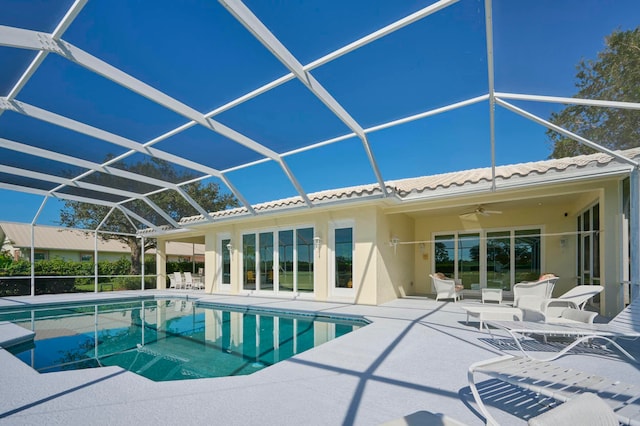 view of swimming pool featuring a lanai, ceiling fan, and a patio area