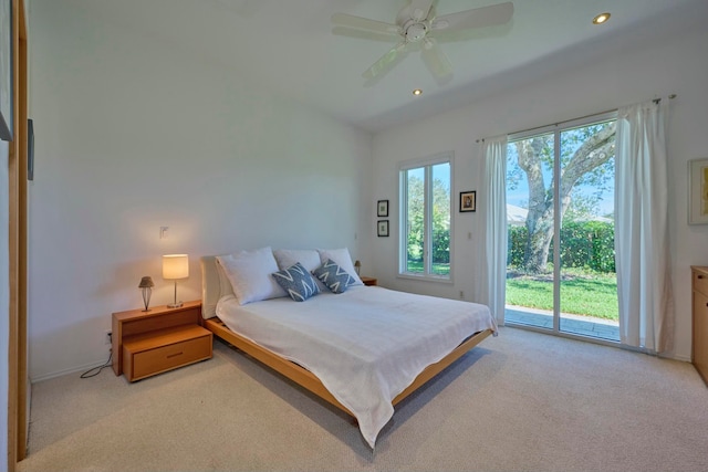 bedroom featuring light carpet, access to exterior, multiple windows, and ceiling fan