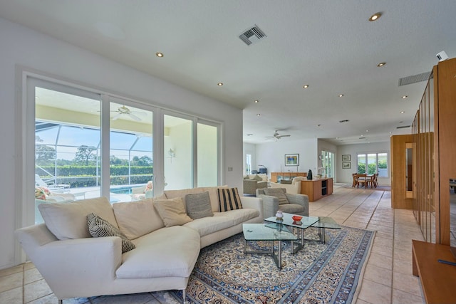 tiled living room with ceiling fan