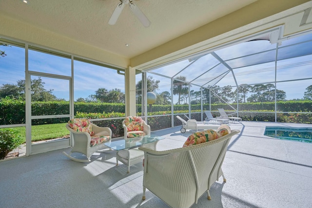 sunroom / solarium featuring ceiling fan