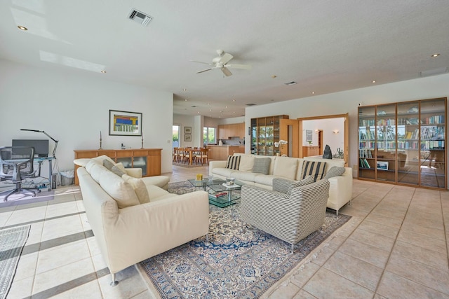 living room with ceiling fan and light tile patterned floors