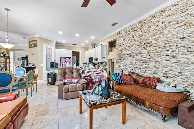 tiled living room featuring ceiling fan, a textured ceiling, and ornamental molding