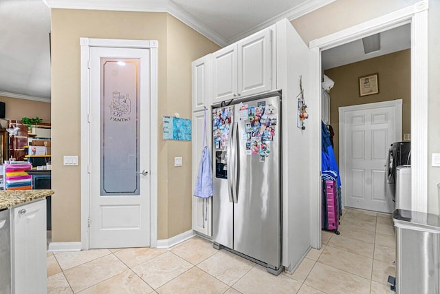 7580 Red River Rd, West Palm Beach, FL 33411 - kitchen with stainless steel refrigerator with ice dispenser, white cabinets, light tile patterned floors, ornamental molding, and baseboards