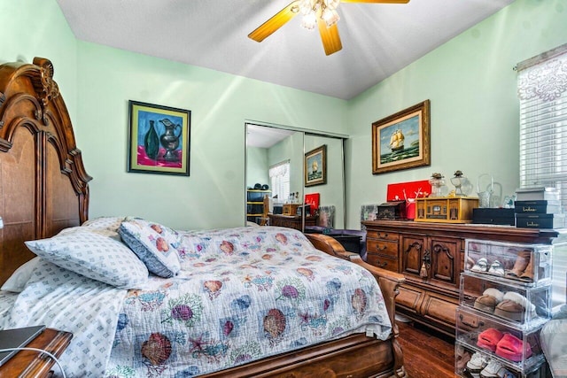 bedroom with hardwood / wood-style floors, ceiling fan, multiple windows, and a closet