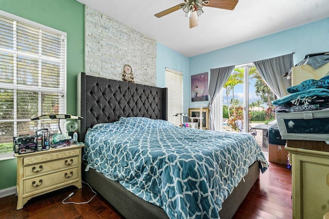 bedroom with access to exterior, dark hardwood / wood-style floors, and ceiling fan