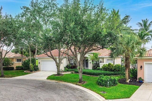 7580 Red River Rd, West Palm Beach, FL 33411 - view of front of house featuring stucco siding, a tiled roof, driveway, a front lawn, and a garage