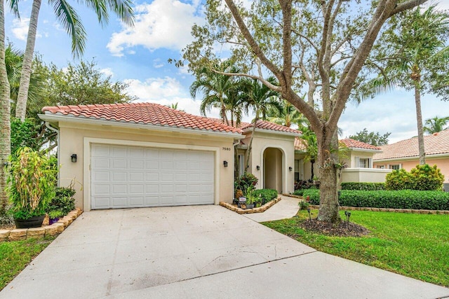 7580 Red River Rd, West Palm Beach, FL 33411 - mediterranean / spanish-style home with concrete driveway, stucco siding, an attached garage, and a tile roof