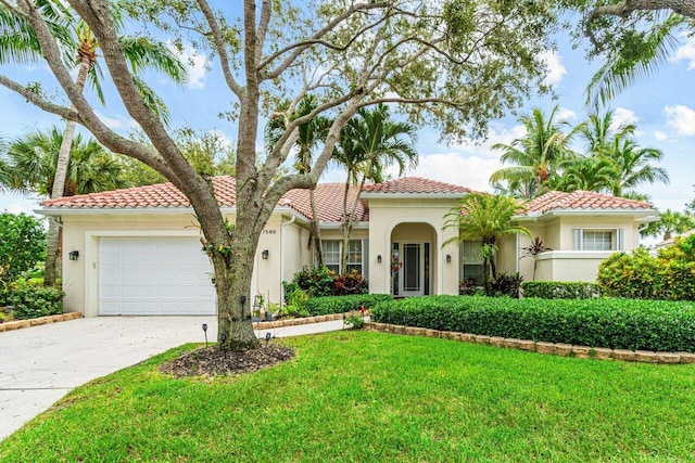 7580 Red River Rd, West Palm Beach, FL 33411 - mediterranean / spanish house with stucco siding, concrete driveway, an attached garage, a tile roof, and a front yard