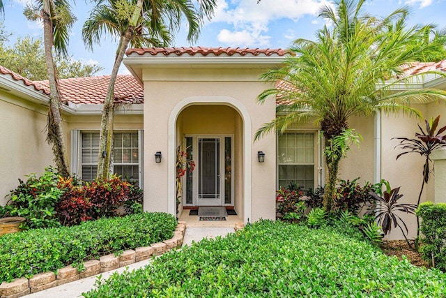 7580 Red River Rd, West Palm Beach, FL 33411 - entrance to property with a tile roof and stucco siding
