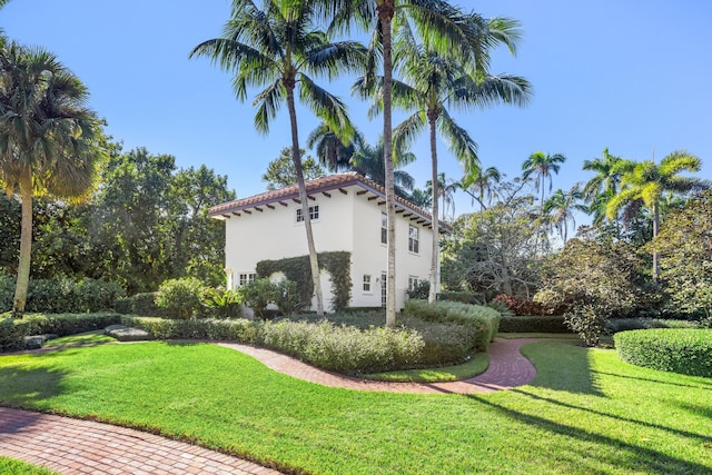 view of side of property with a lawn