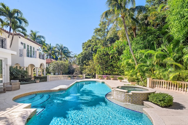 view of pool featuring an in ground hot tub and a patio area