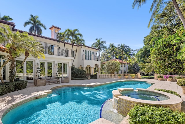 view of pool featuring an in ground hot tub, a patio area, and outdoor lounge area