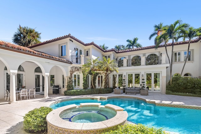 view of pool featuring an outdoor hangout area, an in ground hot tub, a grill, french doors, and a patio area