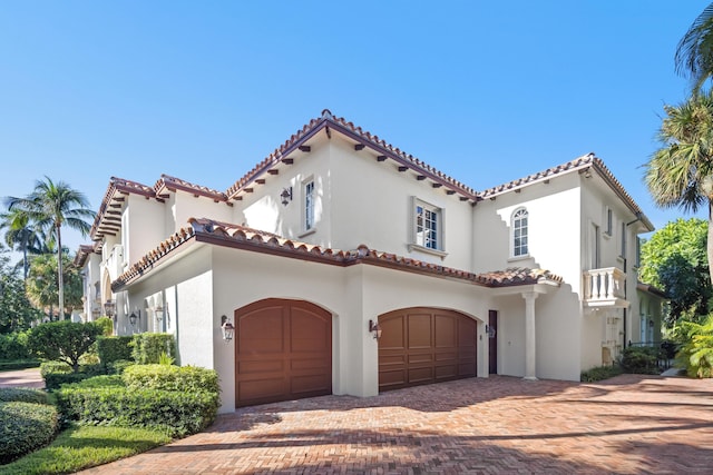 mediterranean / spanish-style home with a garage