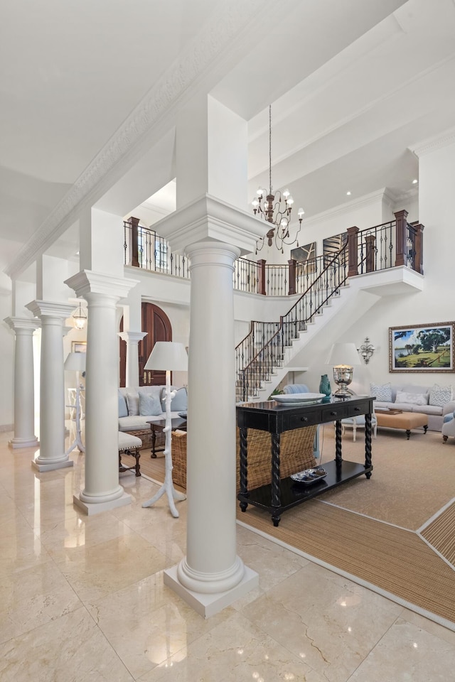 stairs featuring a high ceiling, an inviting chandelier, and ornamental molding