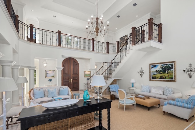 carpeted living room with a high ceiling, a chandelier, and ornamental molding