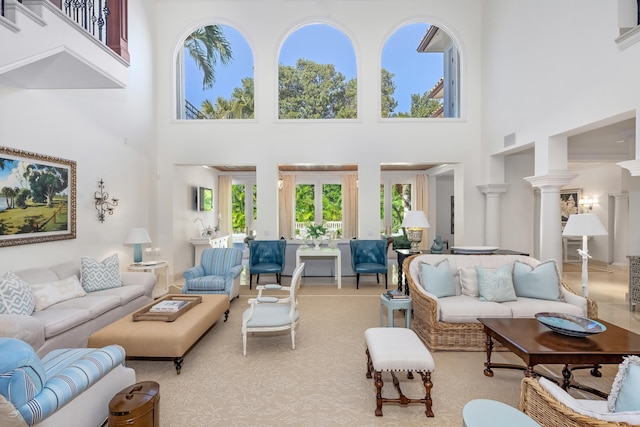 living room with a high ceiling and light carpet