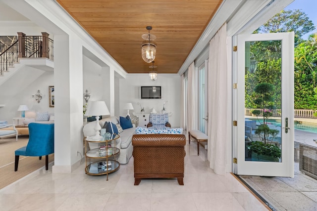 sitting room featuring french doors, crown molding, and wood ceiling