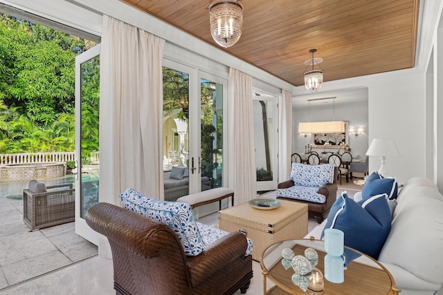 interior space with wood ceiling and a chandelier