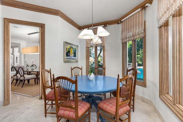 dining area with ornamental molding, an inviting chandelier, and light tile patterned flooring