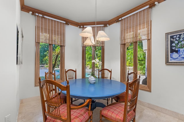 dining area with crown molding and a chandelier