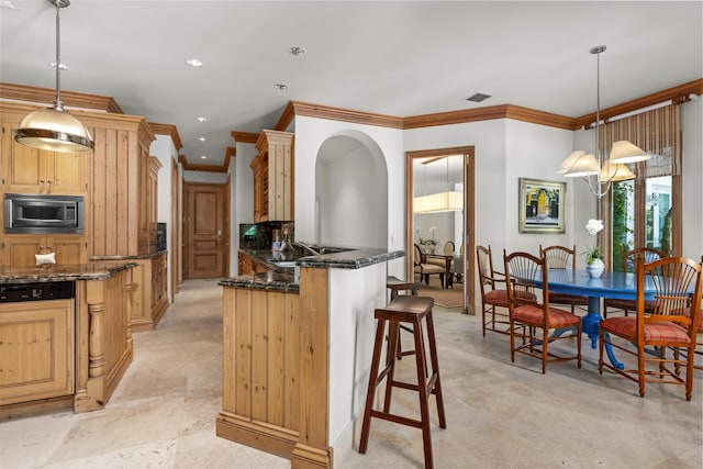 kitchen featuring crown molding, pendant lighting, and built in microwave