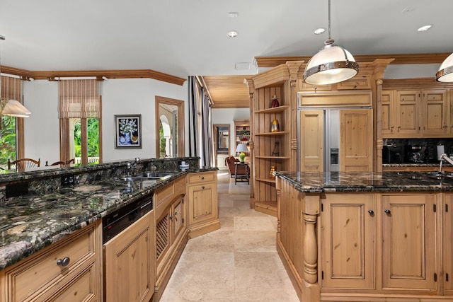 kitchen with sink, paneled fridge, decorative light fixtures, and crown molding