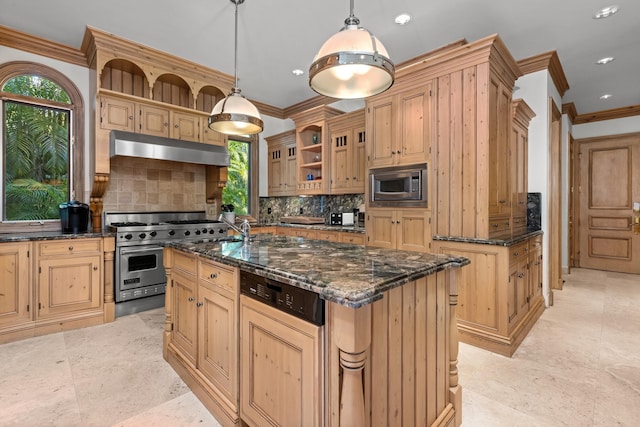 kitchen with a healthy amount of sunlight, decorative light fixtures, tasteful backsplash, a kitchen island with sink, and appliances with stainless steel finishes