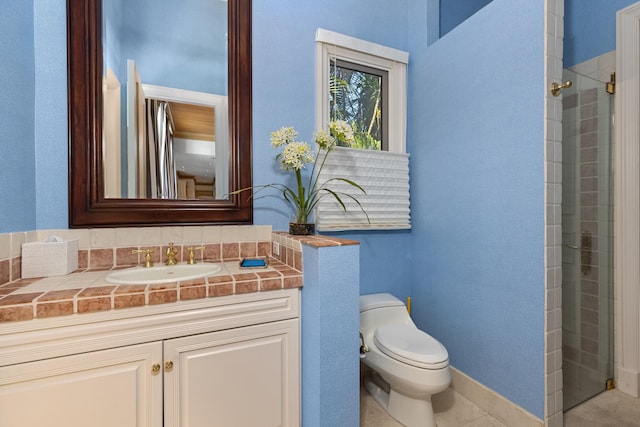 bathroom with vanity, tile patterned floors, a shower with shower door, and toilet