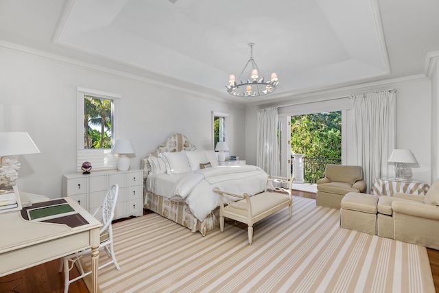 bedroom featuring a raised ceiling, crown molding, and a notable chandelier