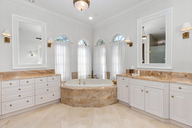 bathroom with ornamental molding, vanity, and tiled bath