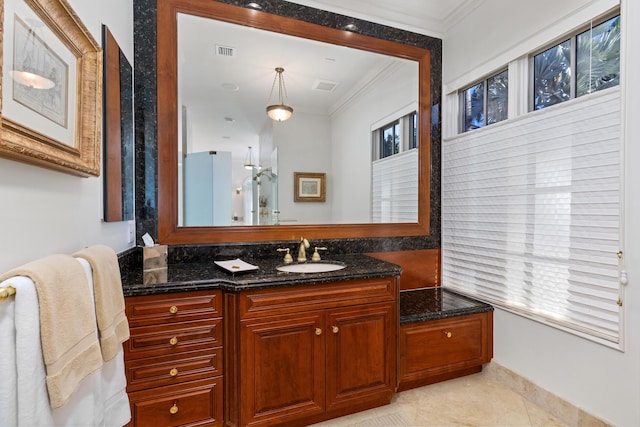 bathroom with ornamental molding, tile patterned flooring, and vanity