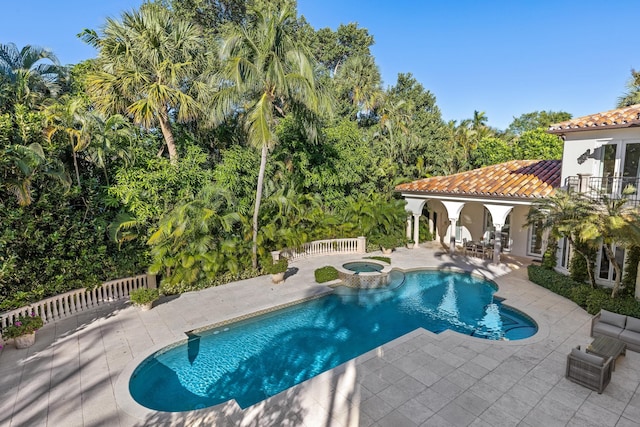 view of swimming pool with a patio area and an in ground hot tub