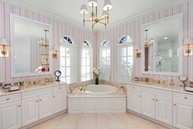 bathroom with a notable chandelier, tile patterned flooring, ornamental molding, and vanity