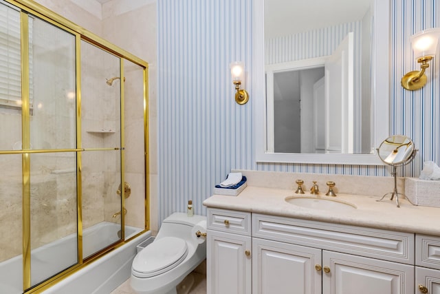 full bathroom with combined bath / shower with glass door, vanity, and toilet