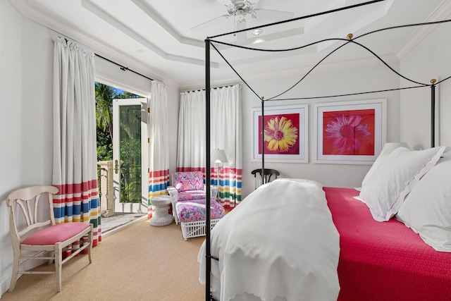 carpeted bedroom featuring ceiling fan, ornamental molding, a raised ceiling, and access to exterior