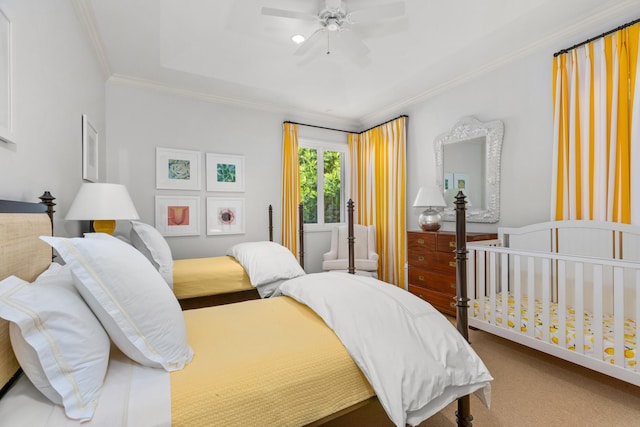 carpeted bedroom with ceiling fan and ornamental molding