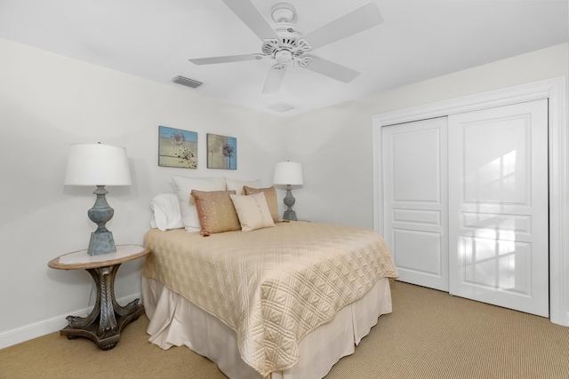 carpeted bedroom featuring a closet and ceiling fan