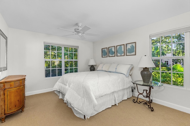 bedroom featuring light carpet and ceiling fan