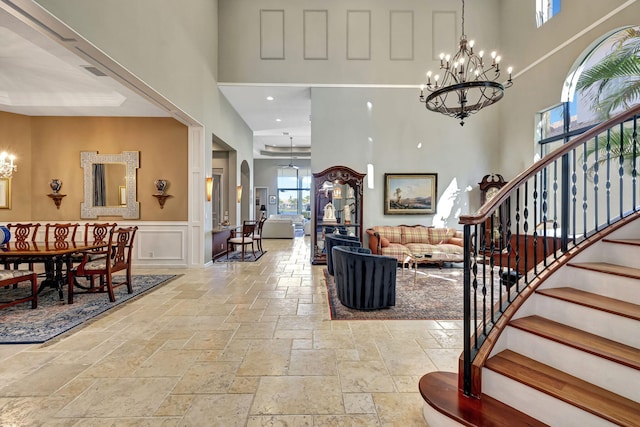 foyer with a chandelier and a high ceiling