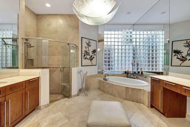 bathroom with vanity, a healthy amount of sunlight, and shower with separate bathtub