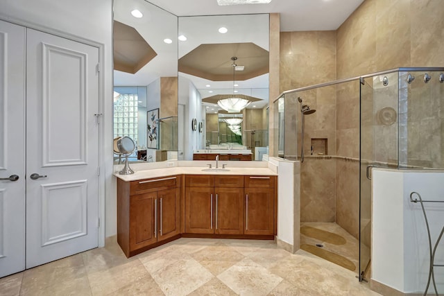 bathroom featuring vanity and a shower with shower door