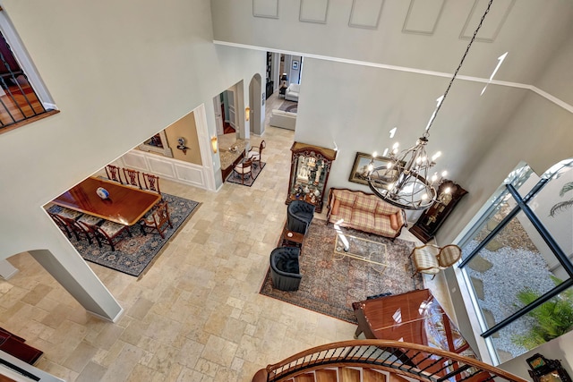 living room with a high ceiling and a notable chandelier