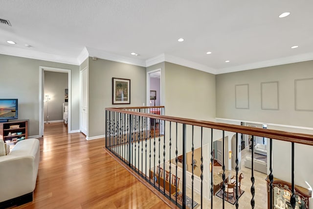 hall featuring light hardwood / wood-style flooring and ornamental molding