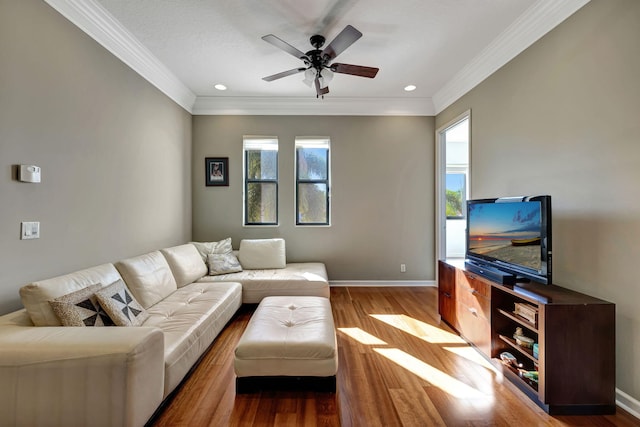 living room featuring a wealth of natural light, hardwood / wood-style floors, and ceiling fan