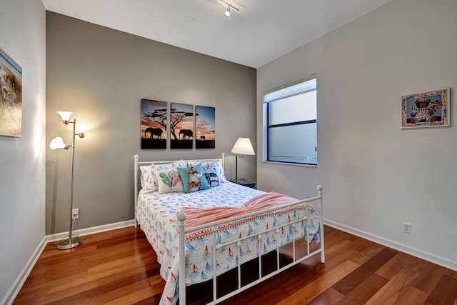 bedroom with hardwood / wood-style floors