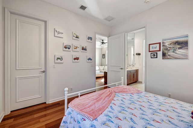 bedroom with wood-type flooring and ensuite bathroom