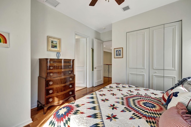 bedroom with ceiling fan, a closet, and hardwood / wood-style flooring