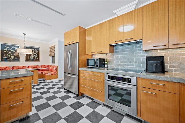 kitchen featuring hanging light fixtures, stainless steel appliances, tasteful backsplash, and ornamental molding