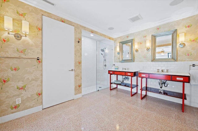 bathroom featuring crown molding, vanity, and tiled shower